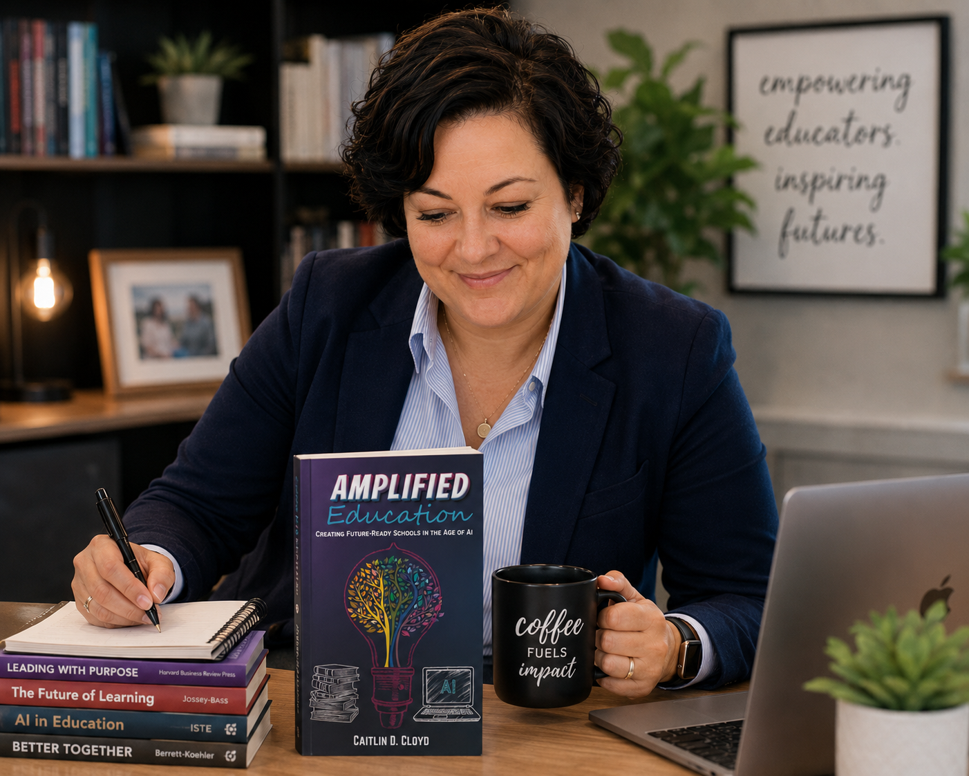 Caitlin Cloyd writing beside her Amplified Education book